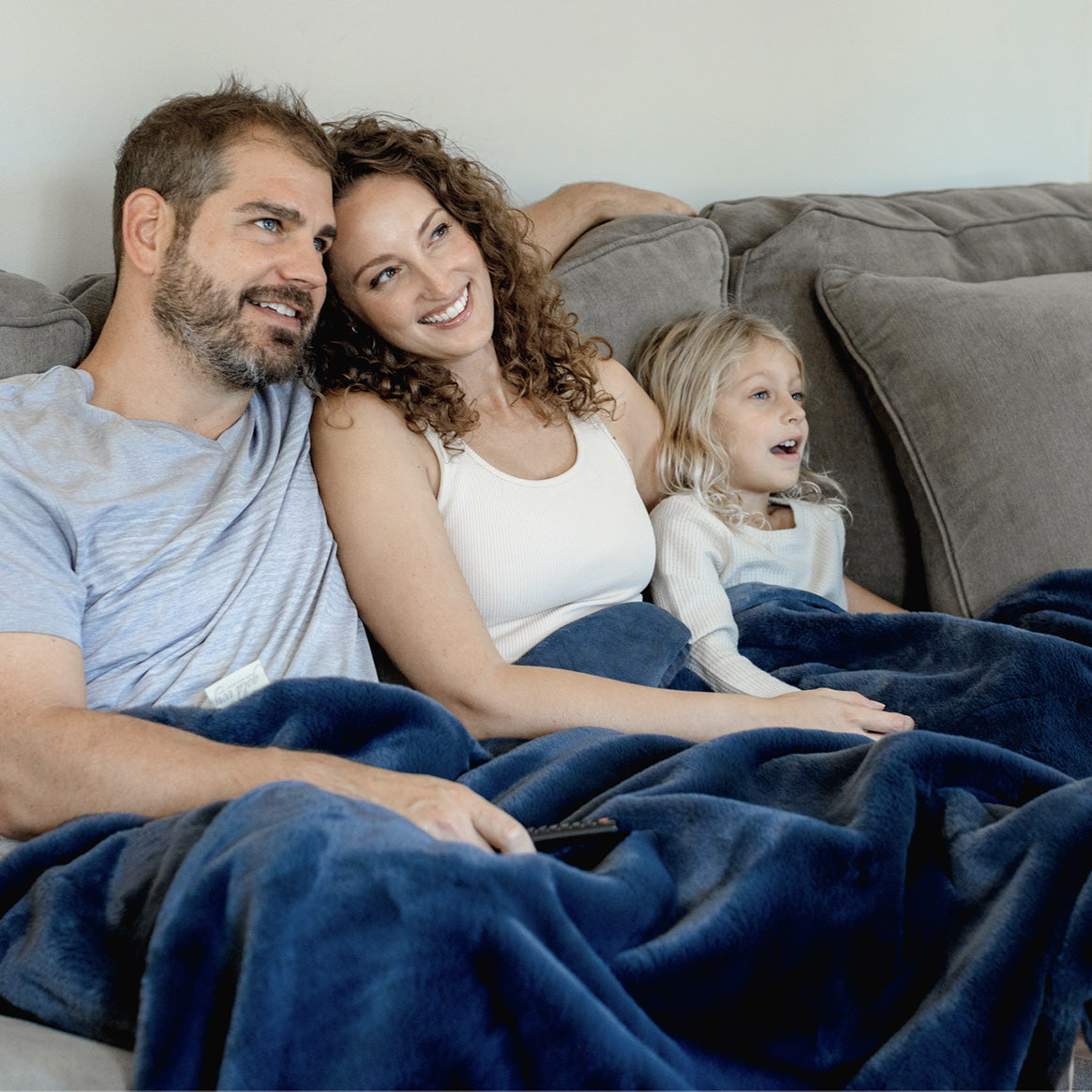 Family with blue cozy throw blanket