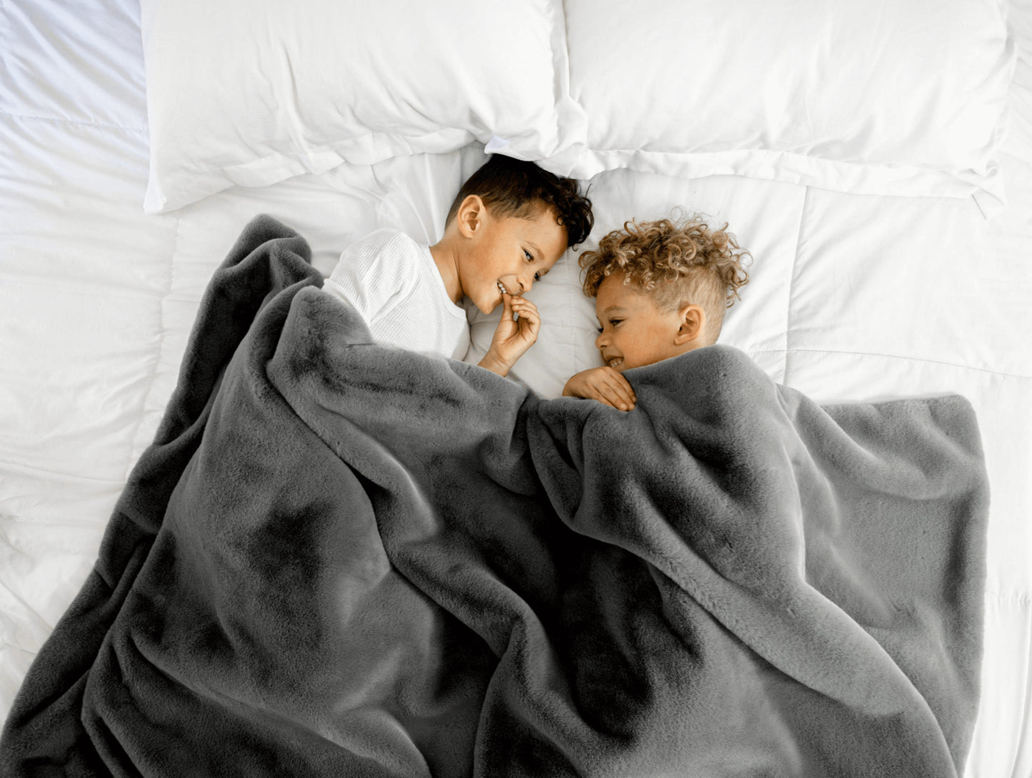 kids with grey throw blanket